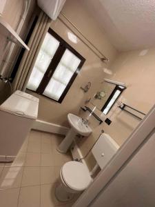 a bathroom with a toilet and a sink and a window at Apartment in Ledro - Ledrosee 43436 in Ledro +27 photos