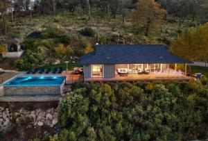 an aerial view of a house with a swimming pool at Vineyard Setting With 180 Panoramic Lake Views in Lower Lake