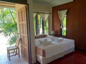 a bedroom with a large bed and a window at Apache Bar Haad yao in Haad Yao