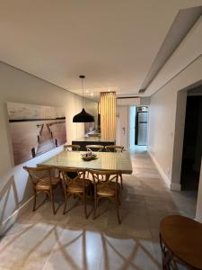 une salle à manger avec une table et des chaises dans l'établissement Apartamento Impecável Completo próximo à praia com Barco Opcional, à Guarujá