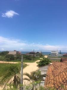 a view of a beach with palm trees and the ocean at Kantinho do Mar in São Francisco do Sul