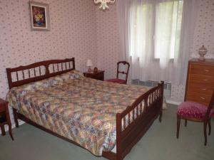 a bedroom with a bed and two chairs and a dresser at Grande villa calme avec jardin à Aix-les-Bains - FR-1-555-71 in Aix-les-Bains +9 photos