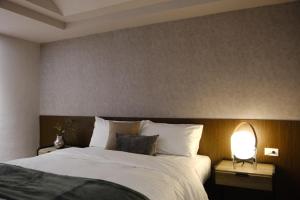 Postel nebo postele na pokoji v ubytování Giant Rich Hotel