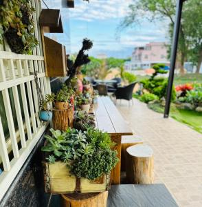 a porch with wooden tables and potted plants on it at Summer Love Villa in Jinning