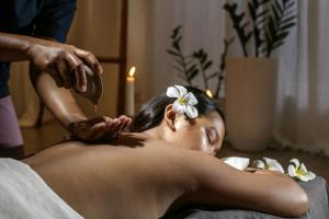 a woman getting a hair cut with a flower on her head at Ocean Vida Beach and Dive Resort in Daanbantayan