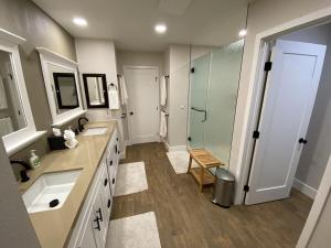 a large bathroom with two sinks and a shower at Upscale Palm Valley Condo-Acrisure Arena 4mi-El Paseo 6mi-Club Privileges Golf, Tennis, Pickleball in Palm Desert