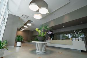 a lobby with potted plants in a building at Resort de Reserva del Mar in Santa Marta +64 photos