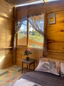 a bedroom with a bed in a room with a window at Du Miên House in Da Lat