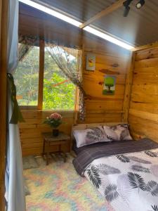 a bedroom with a bed in a log cabin at Du Miên House in Da Lat