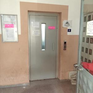a door in a building with a sign on it at Low-Cost City Studio in Mitrovicë +13 photos