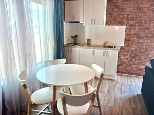 a small kitchen with a white table and chairs at Western Plains Tourist Park - Dubbo in Dubbo