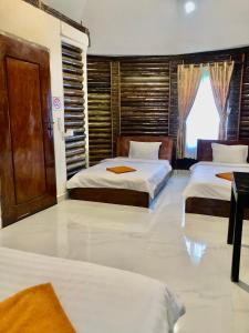 a bedroom with two beds and a window at M'pay Bay Guesthouse in Koh Rong Sanloem