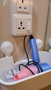 a table with a hair dryer and a power outlet at 6pax Homestay Resort Suite 1min to Sunway Pyramid in Petaling Jaya