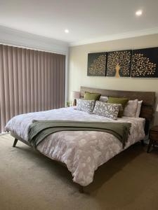 a bedroom with a large bed in a room at The Hideaway Jervis Bay in Vincentia