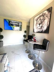 a waiting room with a table and a lion on the wall at 3 miles to Siesta Key #1 Beach in America in Sarasota