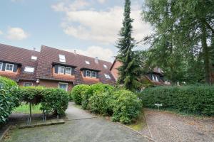 a house with a lot of bushes in front of it at Gorch-Fock-Park App 3 in Timmendorfer Strand