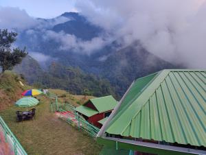 a view of a mountain with umbrellas and a building at LaSerene The Cottage in Nainital