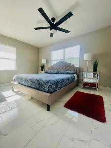 a bedroom with a bed and a ceiling fan at 3 miles to Siesta Key #1 Beach in America in Sarasota