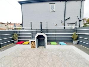 a patio with a fire pit on the side of a house at Family Holiday with Hot tub , Family groups only in Blackpool