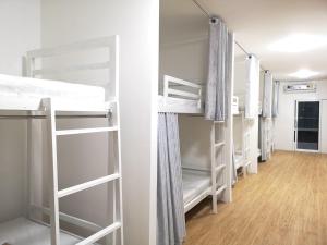 a row of bunk beds in a dorm room at CuteinNan Hostel in Nan