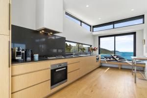 a kitchen with a sink and a stove top oven at Glassy Point - 360 degree views in Wye River