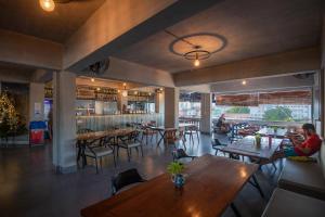 a restaurant with tables and chairs and a bar at Pooltop Phnom Penh in Phnom Penh