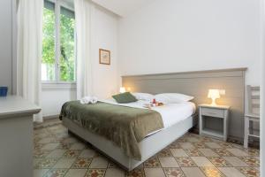 Postel nebo postele na pokoji v ubytování The Leoncino Hotel