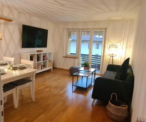 a living room with a couch and a table at Interlaken City Apartments in Interlaken