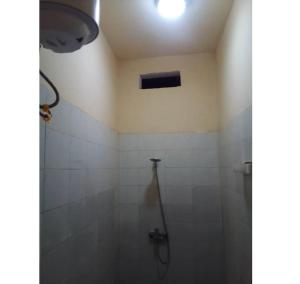 a bathroom with a shower stall with a light at Mini studio meublé à Ngor in Ngor