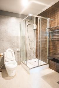 a bathroom with a shower and a toilet at K-Bunk AoNang Center in Ao Nang Beach