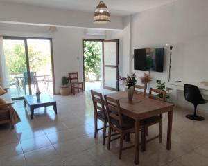 a living room with a wooden table and chairs at Oasis Nature in Polis Chrysochous