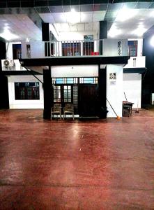 an empty room with a building with a balcony at Beach Guest House Addalaichenai in Addalachenai