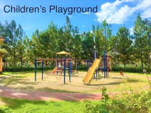 a playground with a slide in a park at Brew Home - 3 Bedroom House in Bacolod