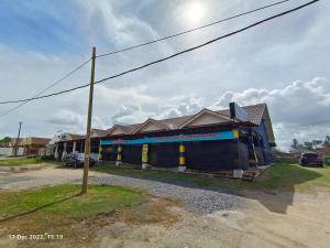 a blue and yellow building on the side of a street at Seaview Promenade Homestay Dungun in Dungun