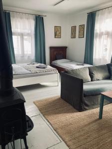 a living room with two beds and a couch at Chalupa Spoko Liptov in Trstené