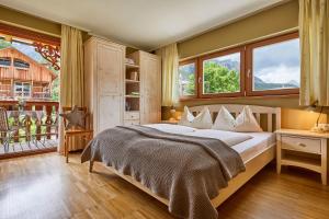 a bedroom with a large bed and a balcony at Appartamenti Les Viles in La Villa