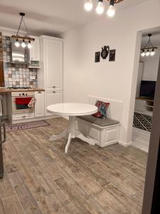 a kitchen with a white table in a room at Apartament English Home 2 camere Brasov in Braşov