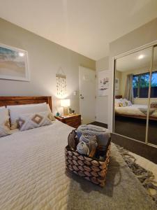 1 dormitorio con 1 cama grande y espejo en Golden Pearl, en Christchurch