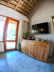 a living room with a flat screen tv on the wall at The Makokola Retreat in Mponda