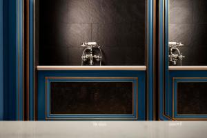 a bathroom with two sinks with blue and white at Maison Proust, Hotel & Spa La Mer in Paris