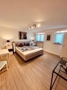 a bedroom with a bed and a living room at Ostseehaus Dreesen Souterrain in Timmendorfer Strand