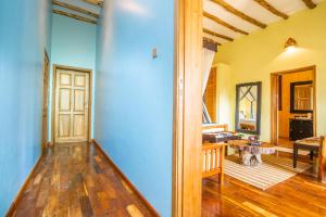 a living room with a wooden floor and a table at Buffalo Safari Lodge in Katunguru