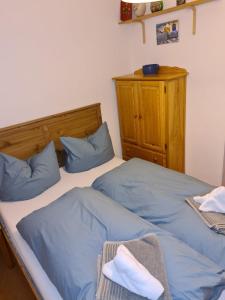 two beds in a room with blue pillows at Bergdiamant in Garmisch-Partenkirchen