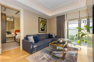 a living room with a blue couch and a table at Acibademflat in Istanbul