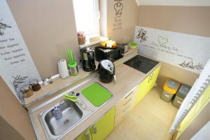a miniature kitchen with a sink and a microwave at Lux Living Apartments BUDIČ near Terme Čatež in Brežice