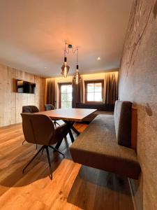 a dining room with a table and chairs at Schulhaus Tirol in Zell am Ziller