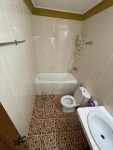 a bathroom with a toilet and a tub and a sink at Apsara Guest House Kampot City in Kampot