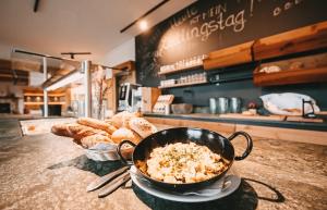 a bowl of food on a counter with a bowl of bread at Posers Bergwelt B&B in Schladming