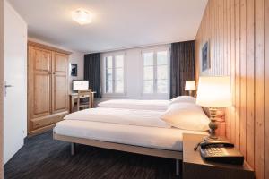 Letto o letti in una camera di Jungfrau Lodge, Swiss Mountain Hotel