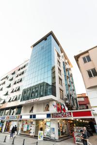 a tall glass building with people walking in front of it at Pamuk City Hotel in Gaziantep